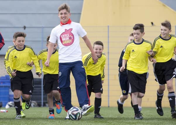 Ryan Gauld joins a group of young hopefuls as he promotes the Toryglen Regional Football Centre. Picture: PA