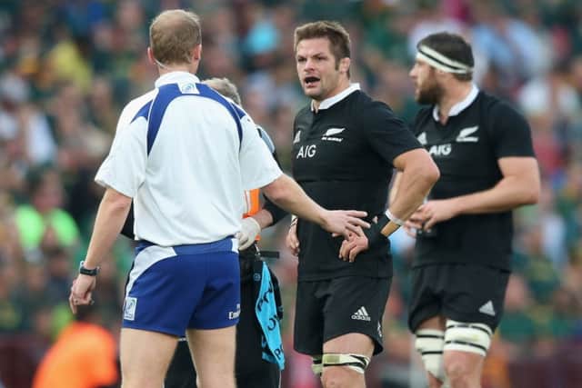 Referee Wayne Barnes talks to All Blacks captain Richie McCaw. Picture: Getty