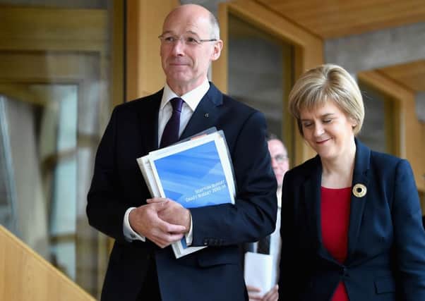 John Swinney and Nicola Sturgeon walk to the Chamber ahead of the 2015/16 Budget plan speech. Picture: Getty