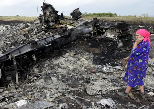A local resident stands among the wreckage of MH17. Picture: Getty