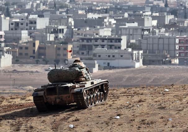 Turkish troops watch from across the Syrian border as battle rages in Kobani. Picture: Getty Images
