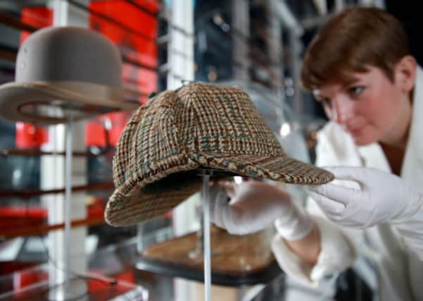 Conservator Melina Plottu prepare a tweed deerstalker hat ahead of the opening of the Sherlock Holmes exhibition. Picture: PA