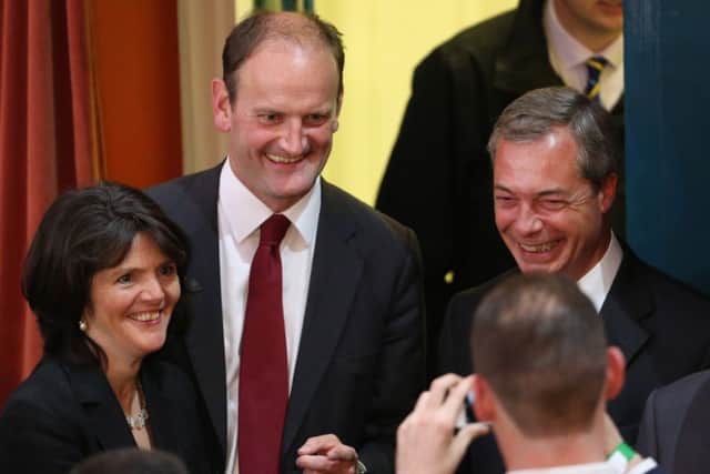 Douglas Carswell, his wife Clementineh and Nigel Farage pose for a photo. Picture: Getty