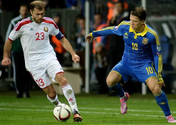 Belarus midfielder Timofei Kalachev (L) fights for the ball with Ukraine forward Yevhen Konoplyanka. Picture: Getty