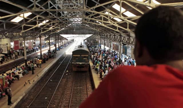 Commuters wait for a train at Fort Station in Colombo. Picture: AP