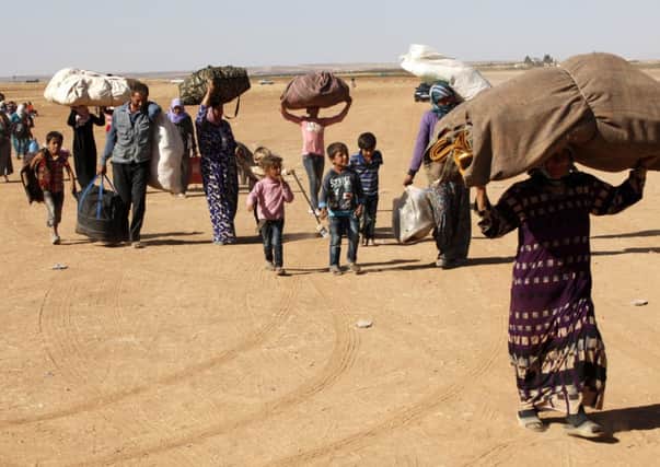 Refugees cross into Turkey from Syria to escape fighting in the border town of Kobani. Picture: Getty