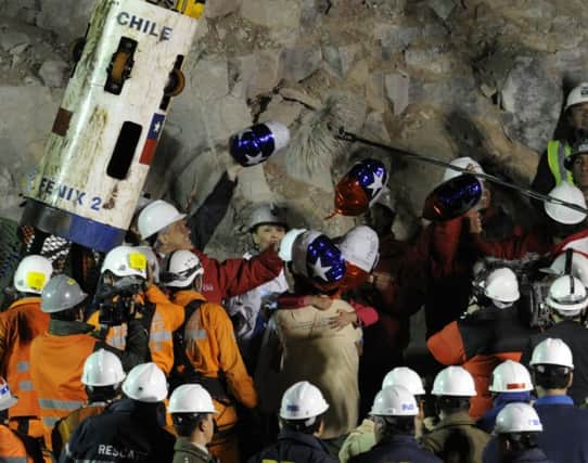 Their 69-day underground ordeal is over, as miners trapped after an accident are brought to the surface on this day in 2010. Picture: Getty
