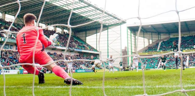 Dumbarton goalkeeper Danny Rogers dives to save a penalty by Hibs Dominique Malonga. Picture: SNS