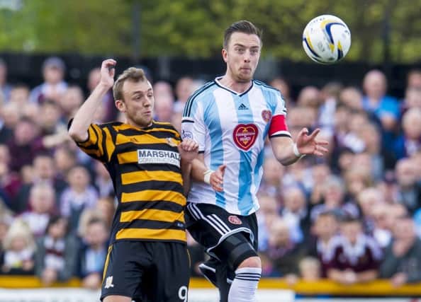 Hearts captain Danny Wilson, right, challenges Greig Spence of Alloa. Picture: SNS