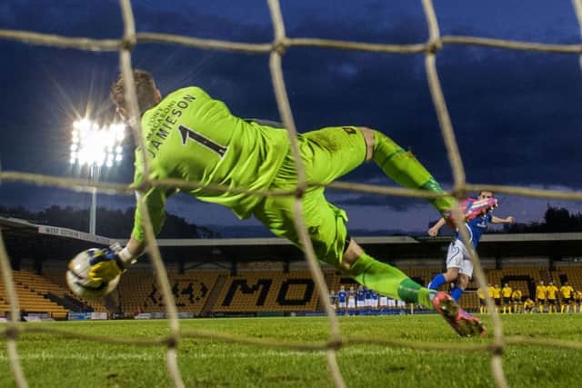 Darren Jamieson saves Anthony Marenghi's penalty to put Livingston through. Picture: SNS