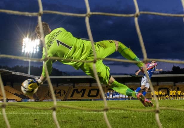 Darren Jamieson saves Anthony Marenghi's penalty to put Livingston through. Picture: SNS