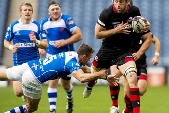 Edinburghs Mike Coman finds his progress halted by Lee Byrne of Dragons at Murrayfield. Picture: SNS/SRU