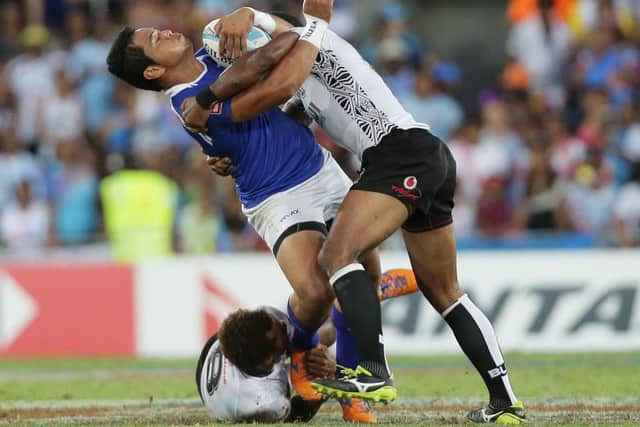 Tofatuimoana Solia of Samoa is tackled by Osea Kolinisau of Fiji during the final. Picture: Getty Images