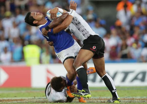 Tofatuimoana Solia of Samoa is tackled by Osea Kolinisau of Fiji during the final. Picture: Getty Images