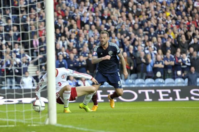 Steven Fletcher looks on as Shaun Maloneys shot strikes Akaki Khubutia of Georgia and spins into the net. Picture: Ian Rutherford