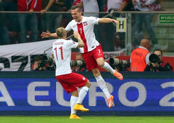 Arkadiusz Milik, right, celebrates scoring the opening goal for Poland against Germany. Picture: Getty