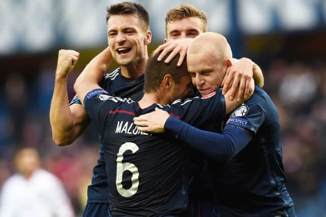 Scotland's Martin (left) and Naismith (right) celebrate with Maloney after Saturday's goal. Picture: SNS