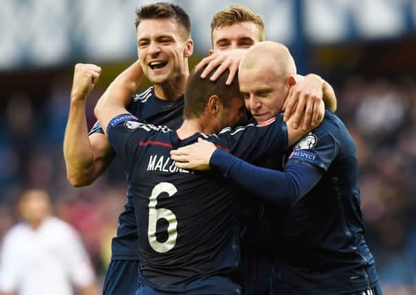 Scotland's Martin (left) and Naismith (right) celebrate with Maloney after Saturday's goal. Picture: SNS