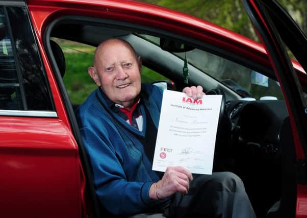 Careful driver: Norman Lawrence, 96, with his advanced driving certificate. Picture: Hemedia