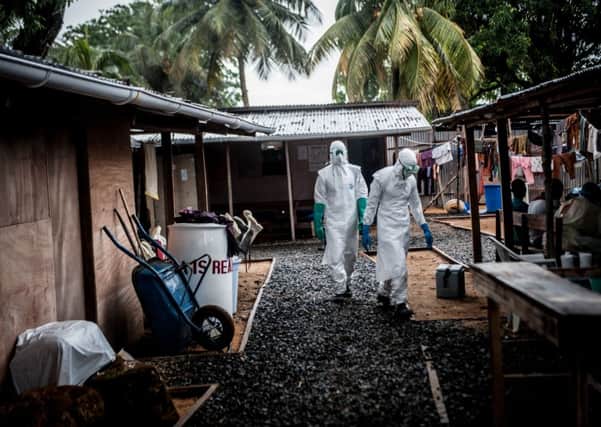 Liberian red cross health workers get ready to pick up Ebola victims who died overnight in Monrovia. Picture: Getty