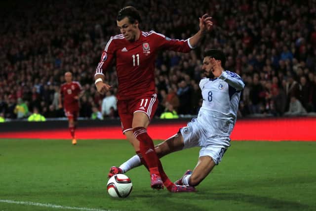 Wales' Gareth Bale (left) is fouled by Cyprus' Charalambos Kyriakou. Picture: PA