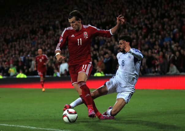 Wales' Gareth Bale (left) is fouled by Cyprus' Charalambos Kyriakou. Picture: PA