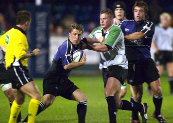 Hugh McMillan, playing for Glasgow Warriors, holds off the challenge of Connachts Paul Neville. The Scot is now working in Hong Kong     Picture: SNS