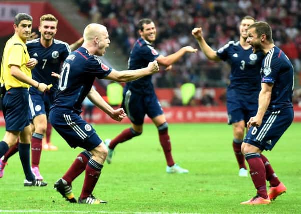 Scotland's Steven Naismith (left) celebrates giving his side the lead with fellow goalscorer Shaun Maloney. Picture: SNS