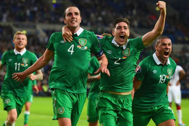 John OShea, left, celebrates his dramatic stoppagetime equaliser with teammates Stephen Ward and Jon Walters, right. Picture: Getty Images