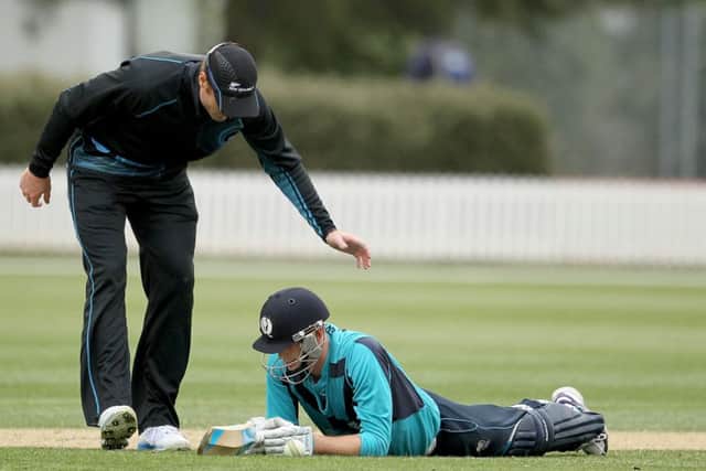 Alasdair Evans is consoled by Martin Guptil after being run out on the last ball. Picture: Getty
