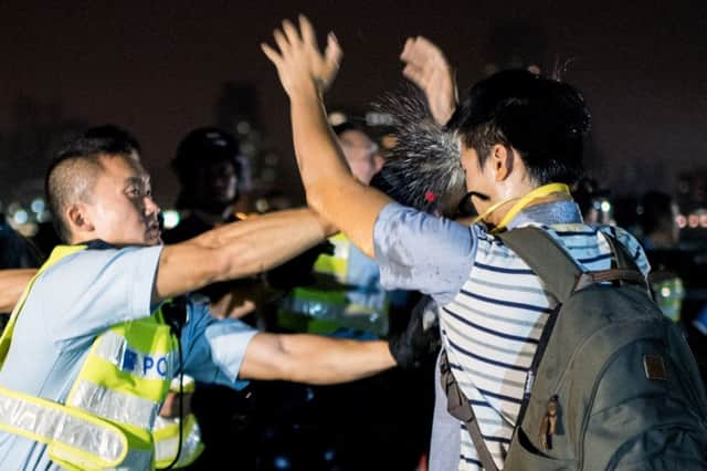 A policeman sprays a protester with pepper spray. Picture: Getty