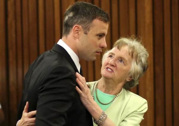 Oscar Pistorius with a supporter in court yesterday. Picture: AP