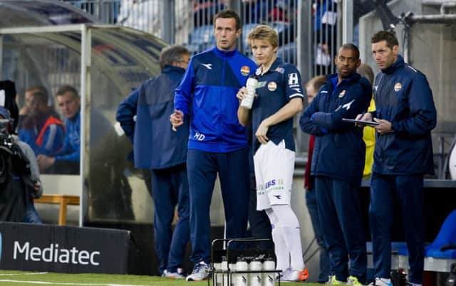 Martin Odegaard watches from the touchline alongside Stromsgodset manager Ronny Deila in April. Picture: PA