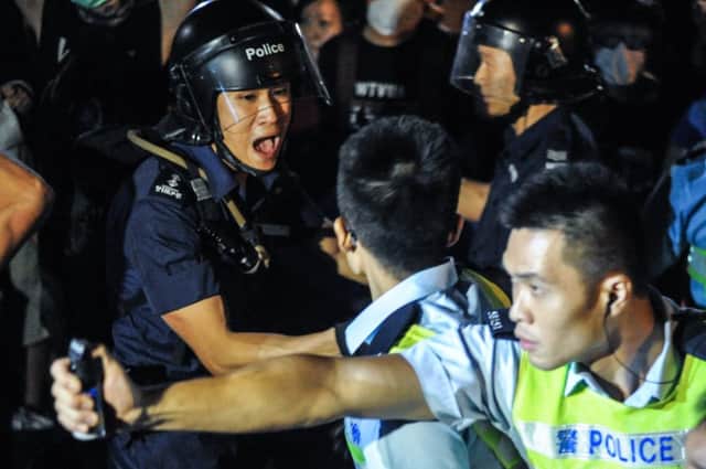 Hong Kong police attempt to use pepper spray on protesters. Picture: Getty