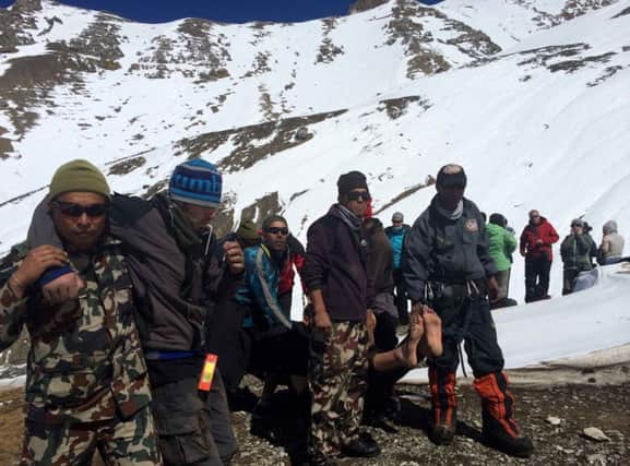 Survivors are helped off the Annapurna range by Nepal army troops. Picture: AFP/ Getty