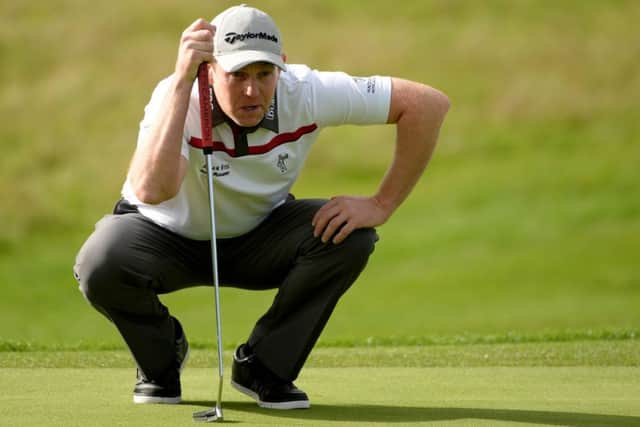Scotlands Stephen Gallacher lines up a vital putt during his win over Victor Dubuisson. Picture: Getty