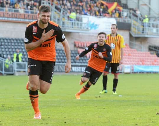 Nadir Ciftci wheels away in celebration after scoring a late winner from the penalty spot. Picture: SNS