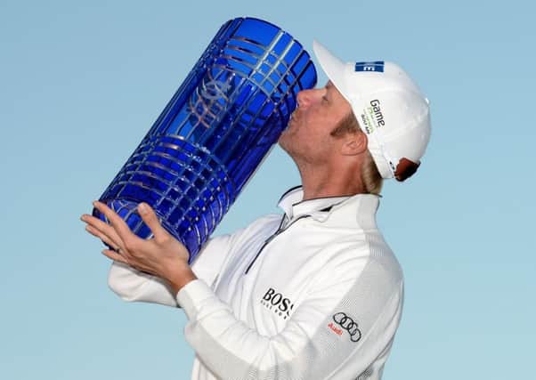 Mikko Ilonen celebrates with the trophy after victory at The London Club. Picture: Ross Kinnaird/Getty Images