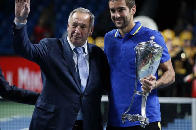 Croatian Marin Cilic is presented with the Kremlin Cup in Moscow by Shamil Tarpischev. Picture: Reuters