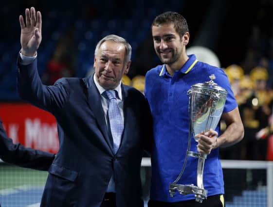 Croatian Marin Cilic is presented with the Kremlin Cup in Moscow by Shamil Tarpischev. Picture: Reuters