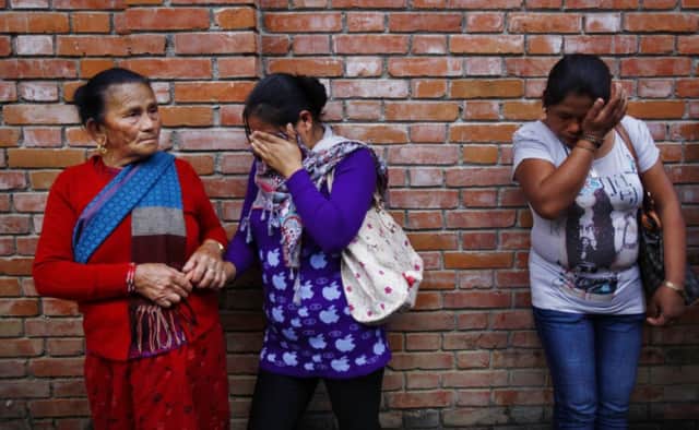 Tearful relatives of Nepalese guides and porters wait to claim bodies at a hospital in Kathmandu. Picture: AP