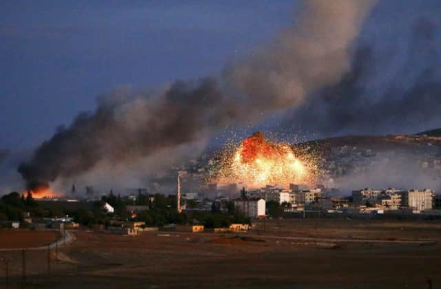 Smoke and flames rise over Syrian town of Kobani after an airstrike. Picture: Reuters