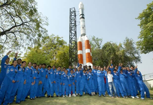 High school students next to a model of the PSLV-C11 rocket at the Indian Space Research Organisation, on this day in 2008. Picture: Getty
