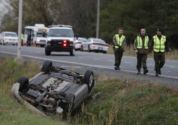 Officers by the car of Martin Rouleau. Picture: Reuters