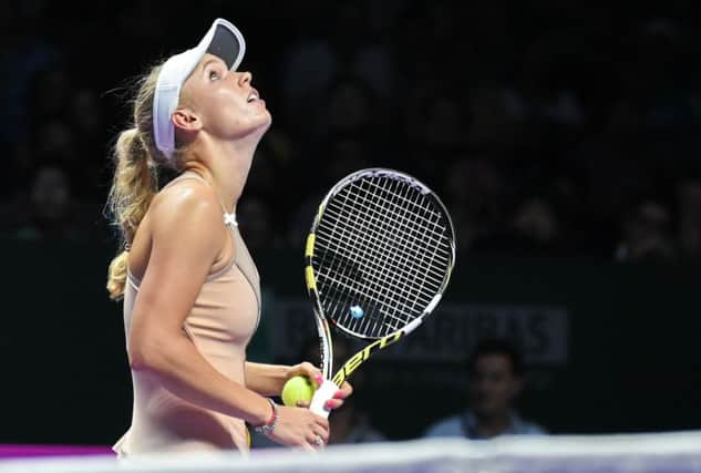 Caroline Wozniacki looks at the lights during her win over Maria Sharapova in Singapore. Picture: AFP/Getty