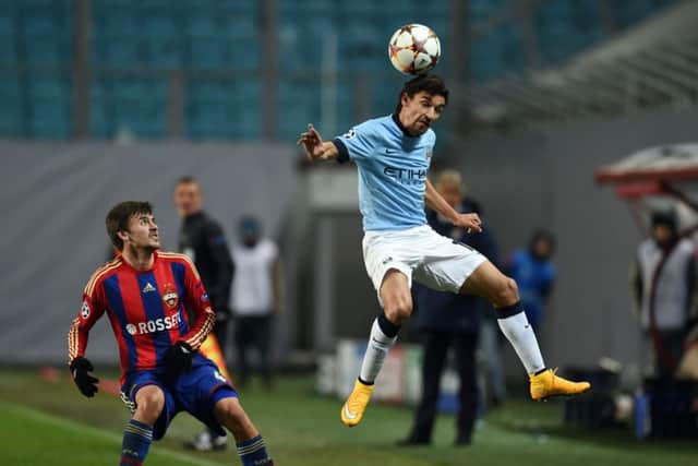 Georgi Schennikov, left, is challenged by Jesus Navas of Manchester City. Picture: Getty