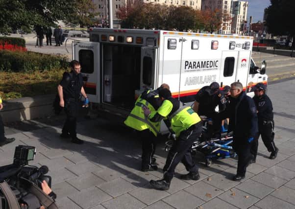 Police and paramedics transport a wounded Canadian soldier on October 22, 2014 in Ottawa, Ontario. Picture: Getty