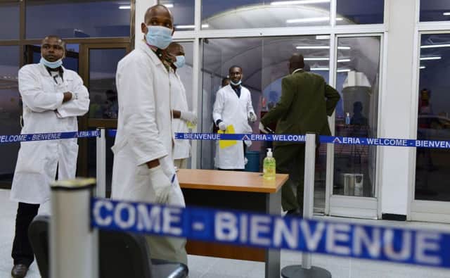 Medical staff wait for passengers arriving in Ivory Coast from Guinea. Picture: Getty
