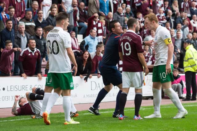 Liam Craig has words with James Keatings in the seasons first derby. Picture: SNS