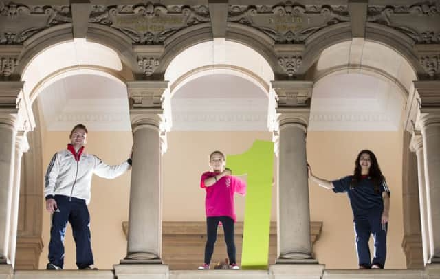 Dan Purvis and Claudia Fragapane at Kelvingrove Art Gallery with local youngster Kacey Morrison. Picture: PA